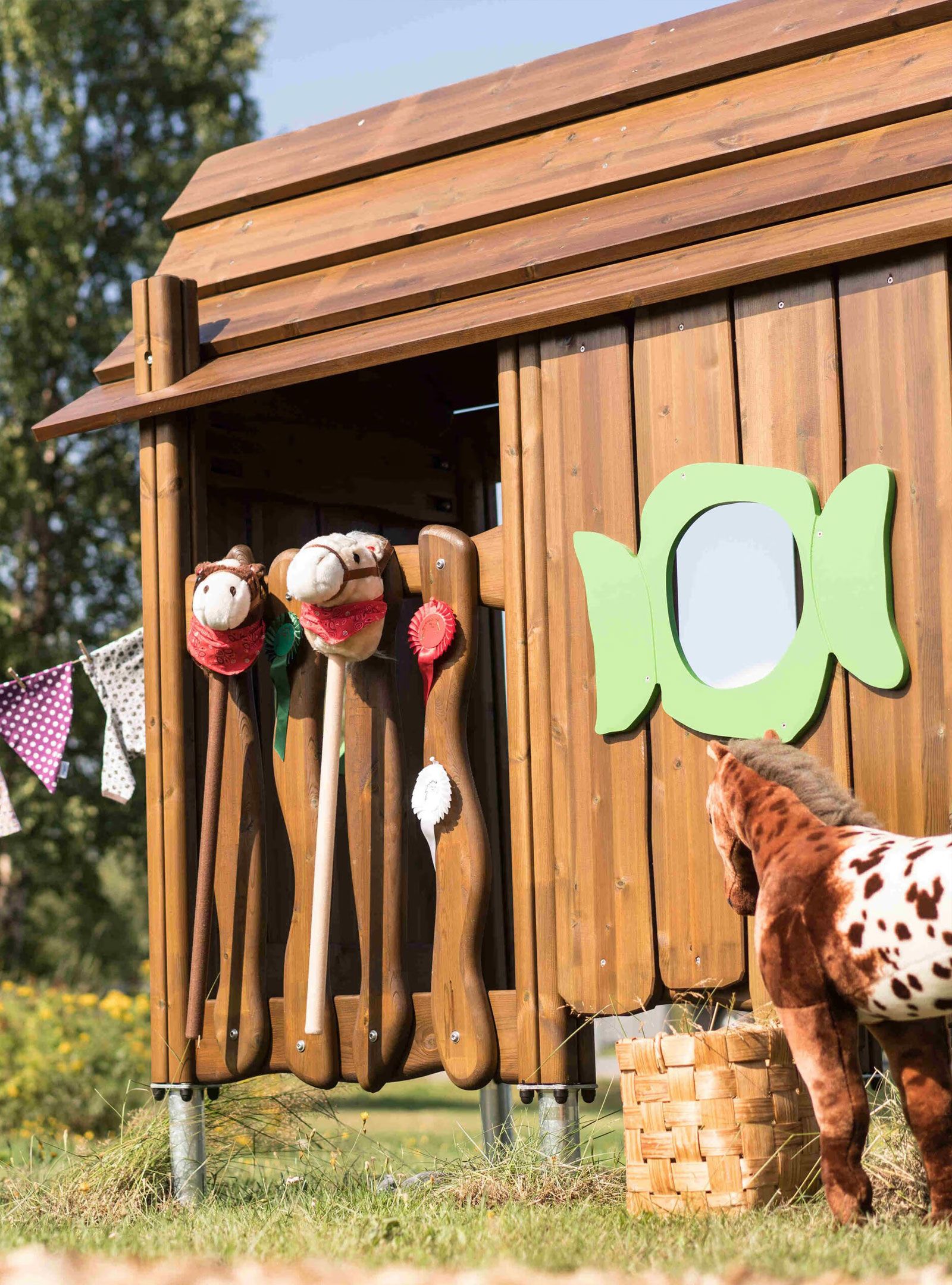 Hobby horses on the side of a small building