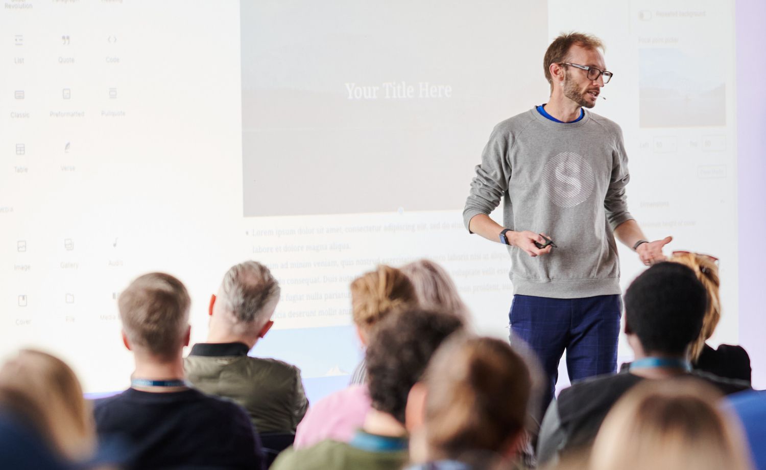 Man speaking to a crowd at a corporate event