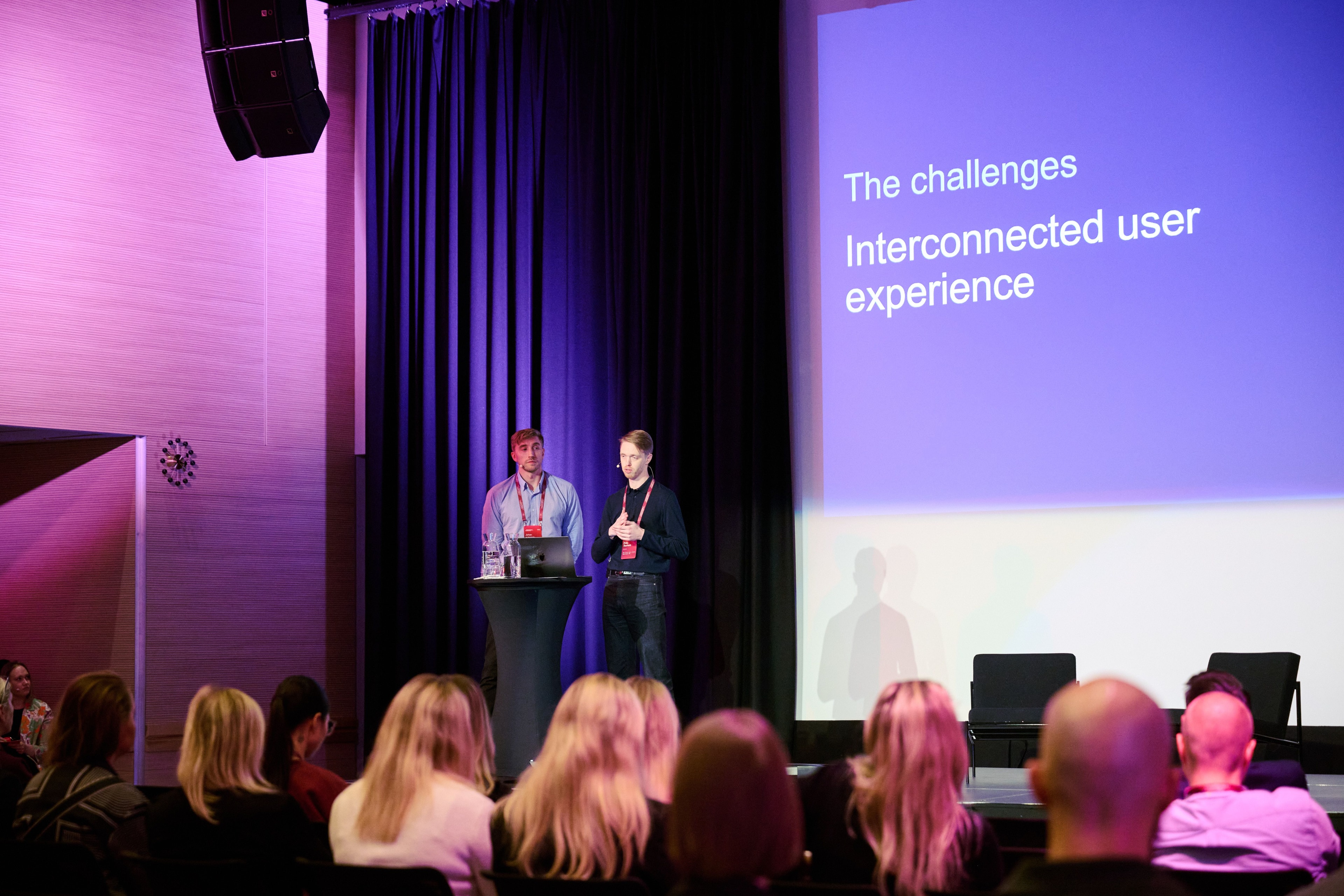Man speaking to a crowd at a corporate event