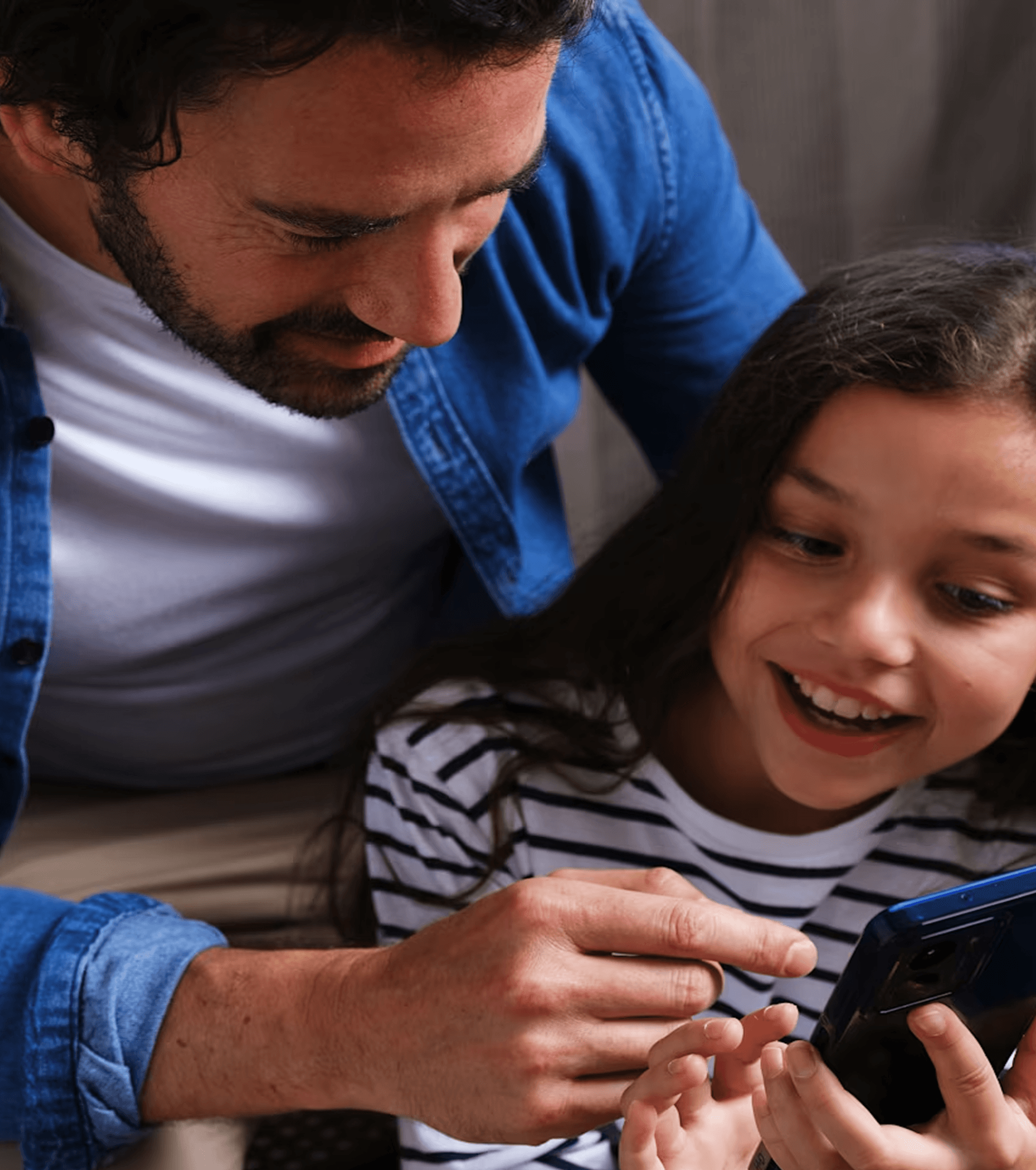 Adult and child looking at phone