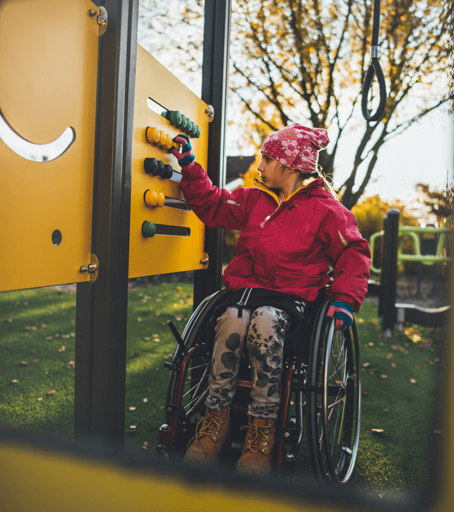 Child on a wheelchair playing with Lappset equipment